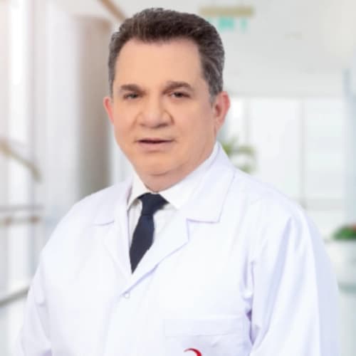 Three-quarter studio portrait of Op. Dr. Alper Aras. Neutral backdrop, soft directional light, hands visible.